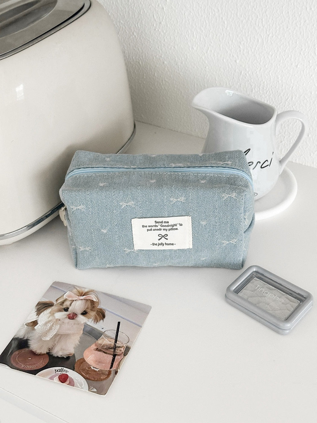 Cosbai soft washed denim pouch displayed with makeup brushes and cosmetics