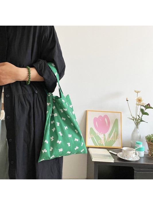 Side view of green puppy slouch tote bag showing strap and shape