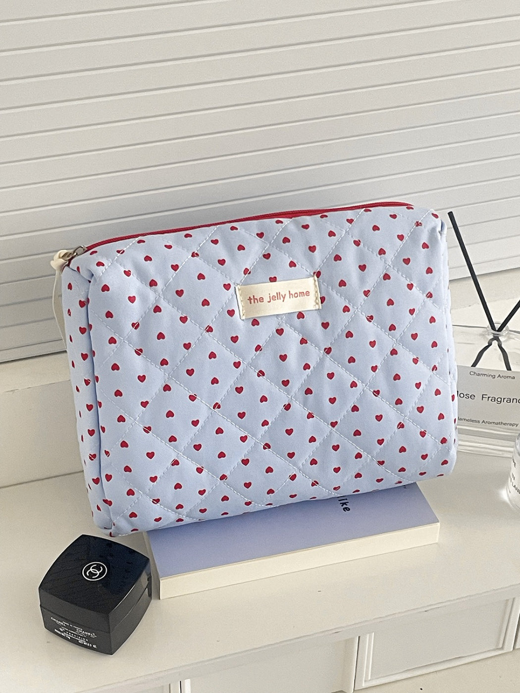 Cosbai lightweight makeup bag with heart quilting, side angle view