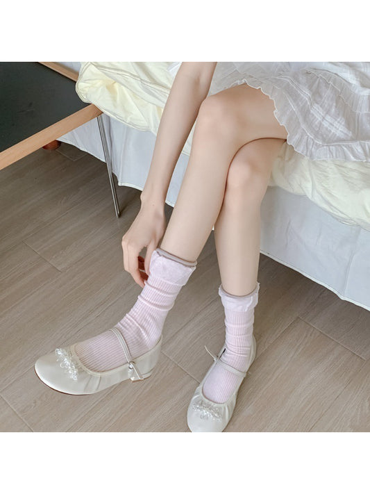 Close-up of ribbed texture and ruffle detail on Rufia crew socks in beige