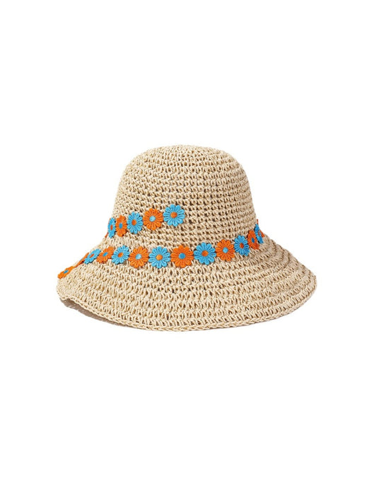 Close-up of Haila sun hat showing woven straw texture and daisy chain decoration