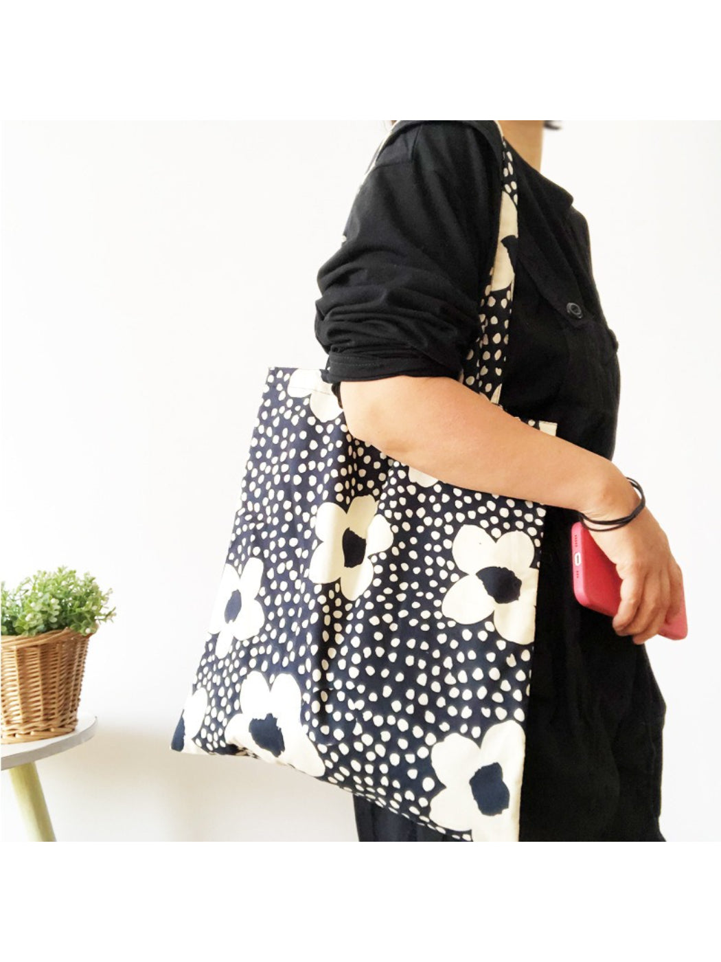 Cosbai tote bag styled with casual outfit on a white background