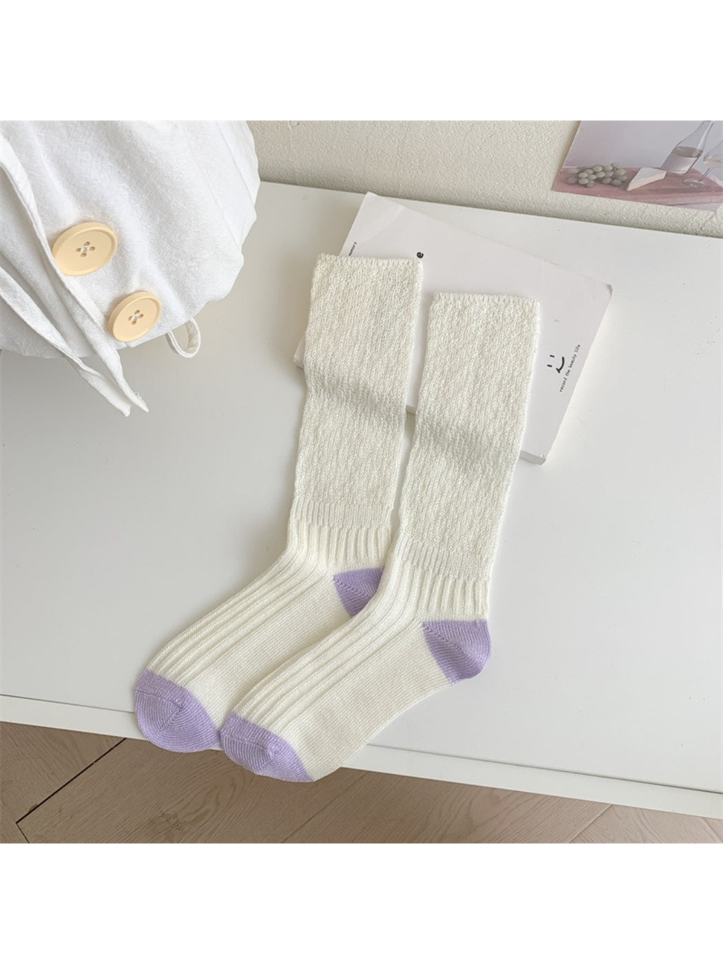Rufia cozy crew socks worn with rolled-up jeans to showcase contrast toe