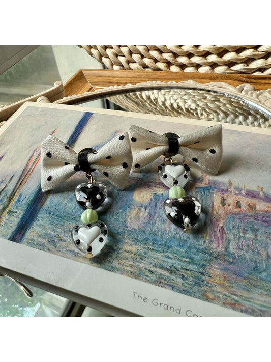 Close-up of Earwish Heart Charm Bow Earrings highlighting heart charm detail