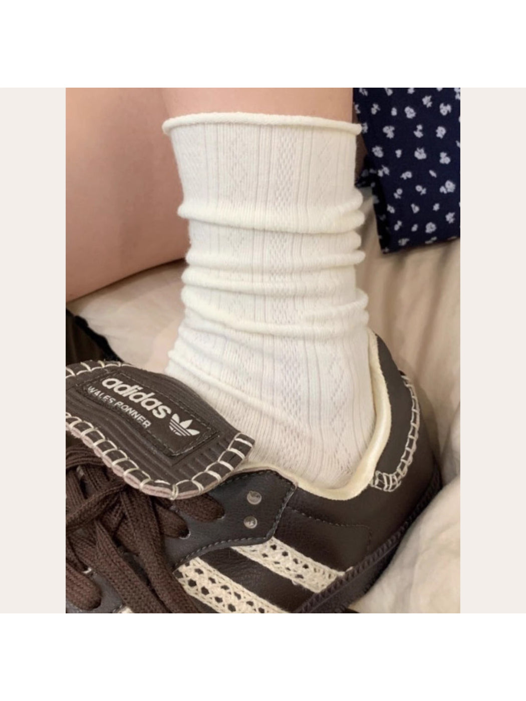 White mid-calf socks folded neatly with visible ribbed cuff