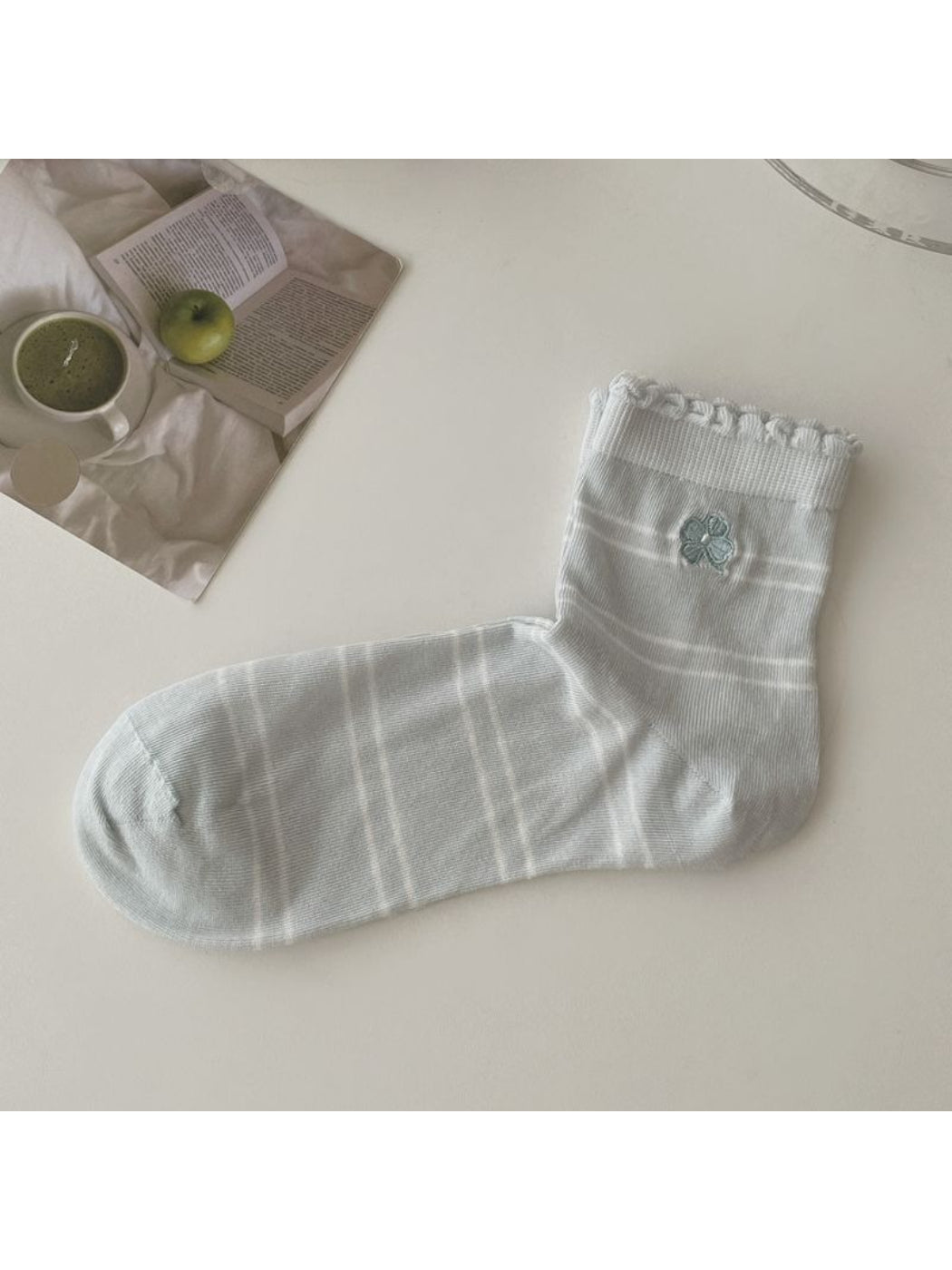 Rufia girly socks paired with a casual outfit on a wooden floor