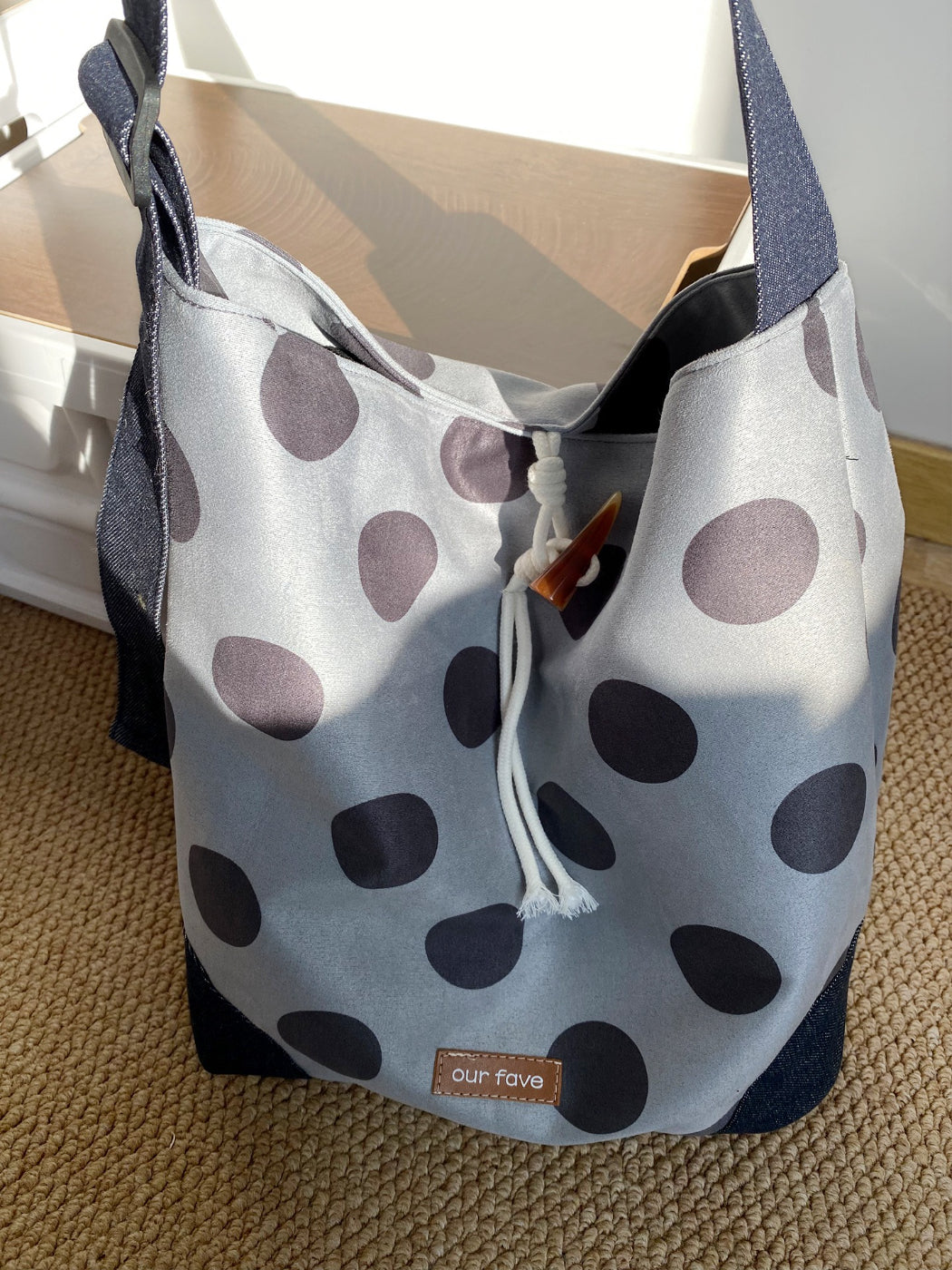 Cosbai polka dot drawstring crossbody bag displayed on white background