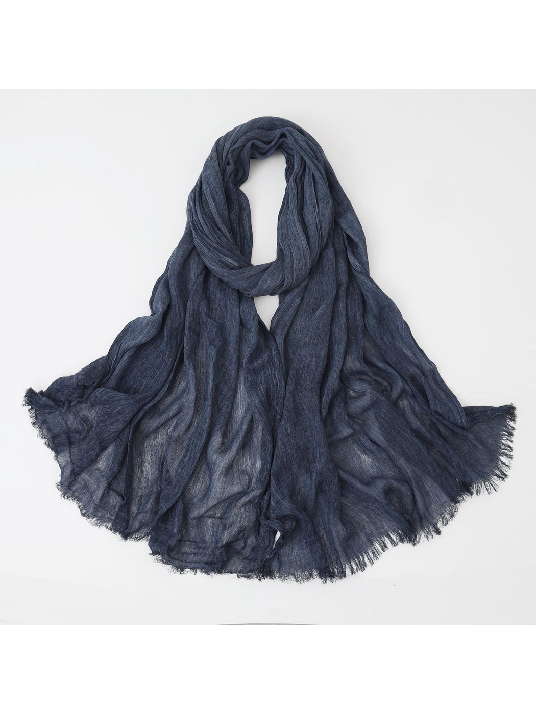Navy scarf looped with crinkled texture and fringed edges