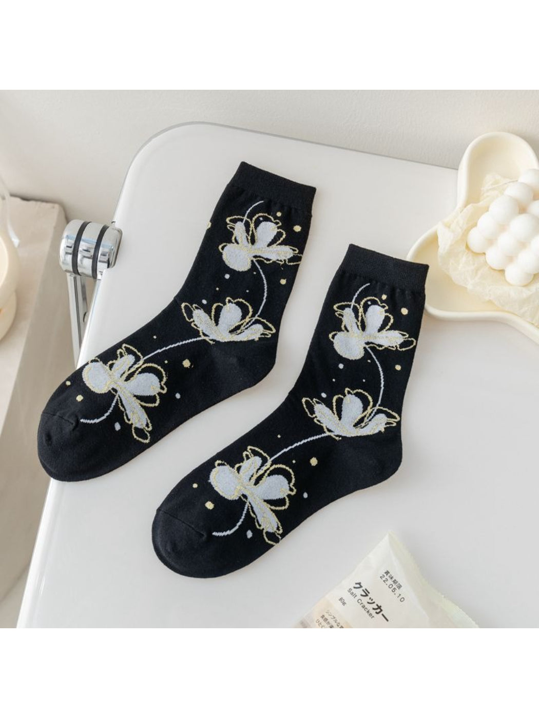 Rufia Painterly Flower Mixed Crew Socks displayed on wooden surface showing vibrant colors
