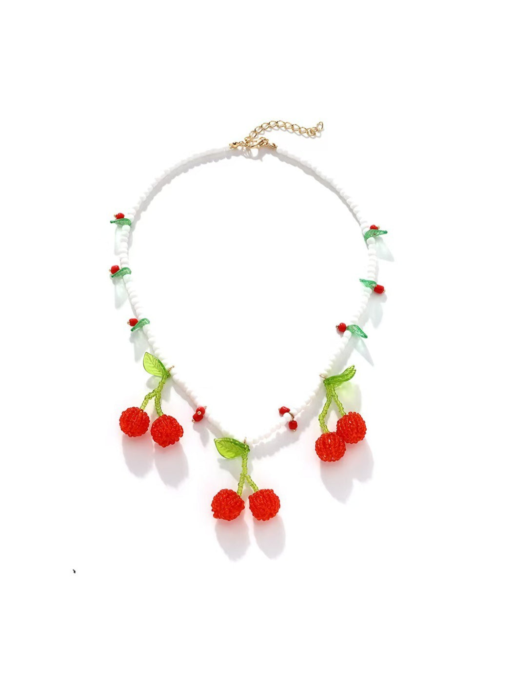 Neckit cherry pendant necklace with white beads arranged on a flat surface