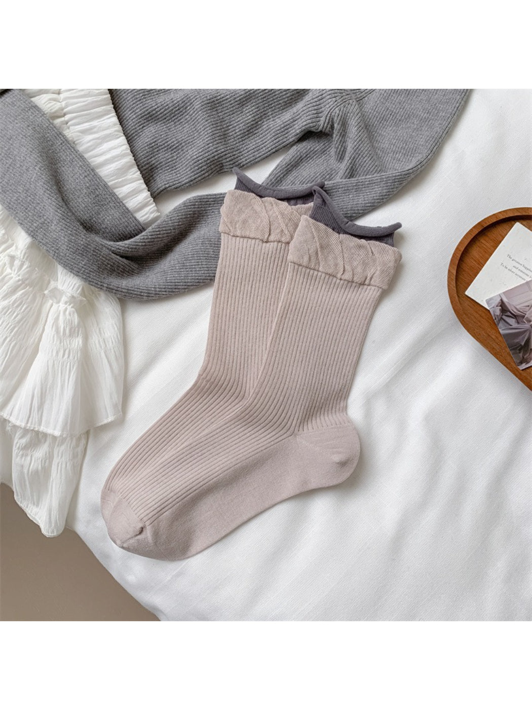 Flat lay of Rufia soft ruffle ribbed crew socks alongside matching accessories
