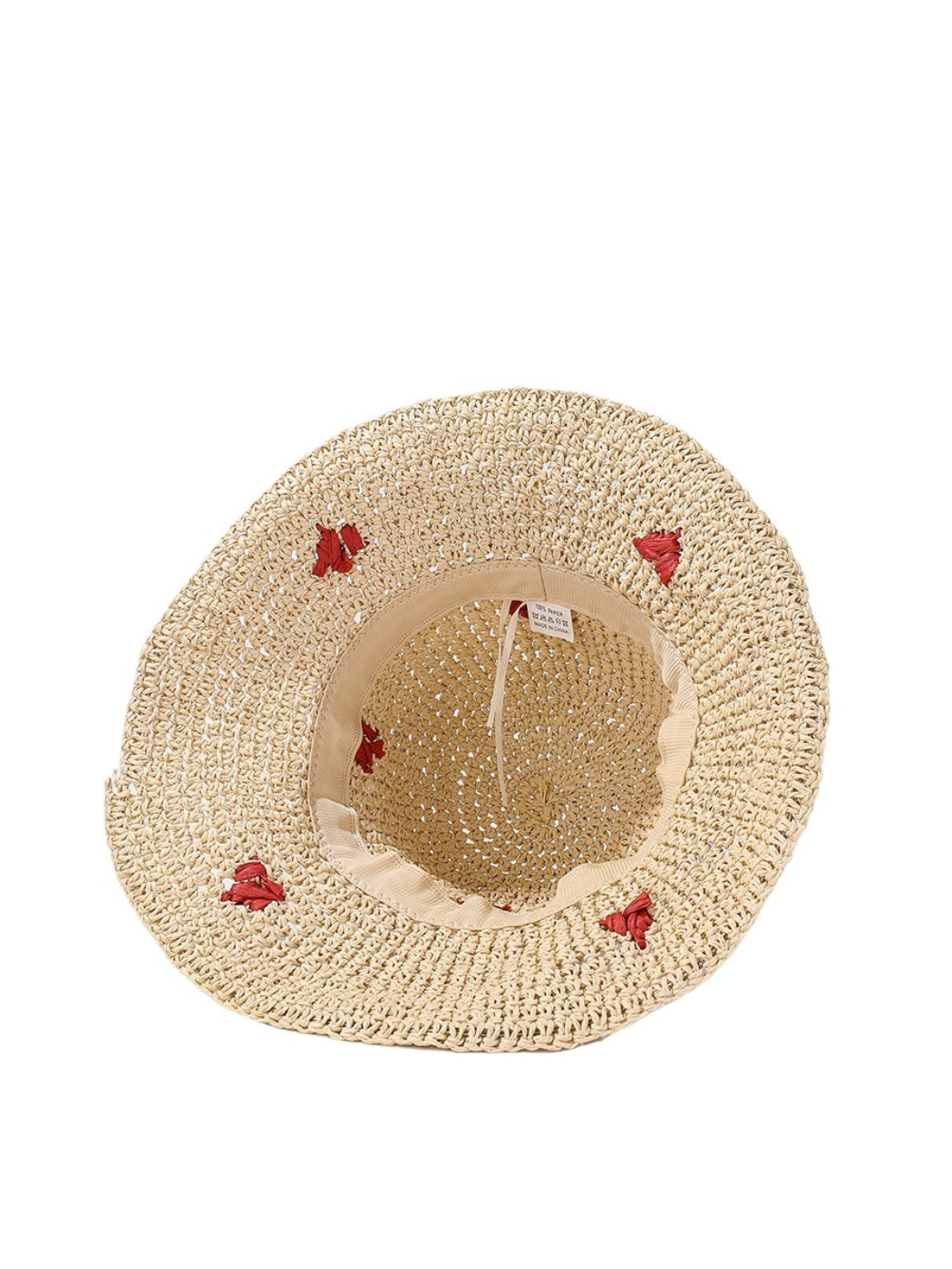 Close-up of the heart detail embroidered on the straw bucket hat