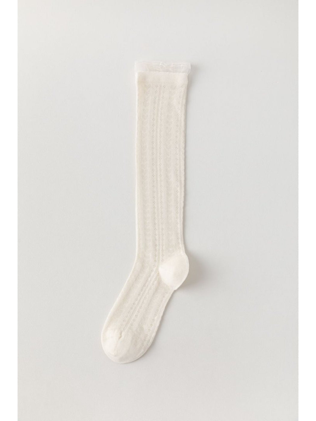 Rufia soft cable knee high socks styled with skirt and boots on model