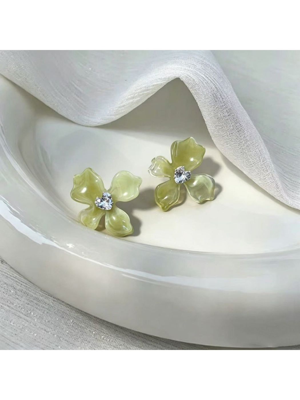 Pair of Earwish soft color floral stud earrings with gold-tone backing and pastel petals