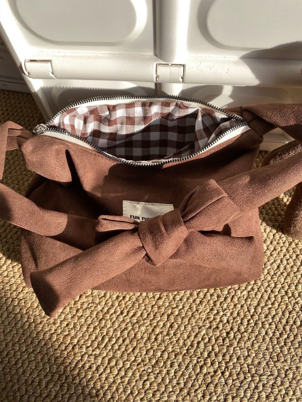 Cosbai everyday shoulder bag hanging on a hook in a minimalist room