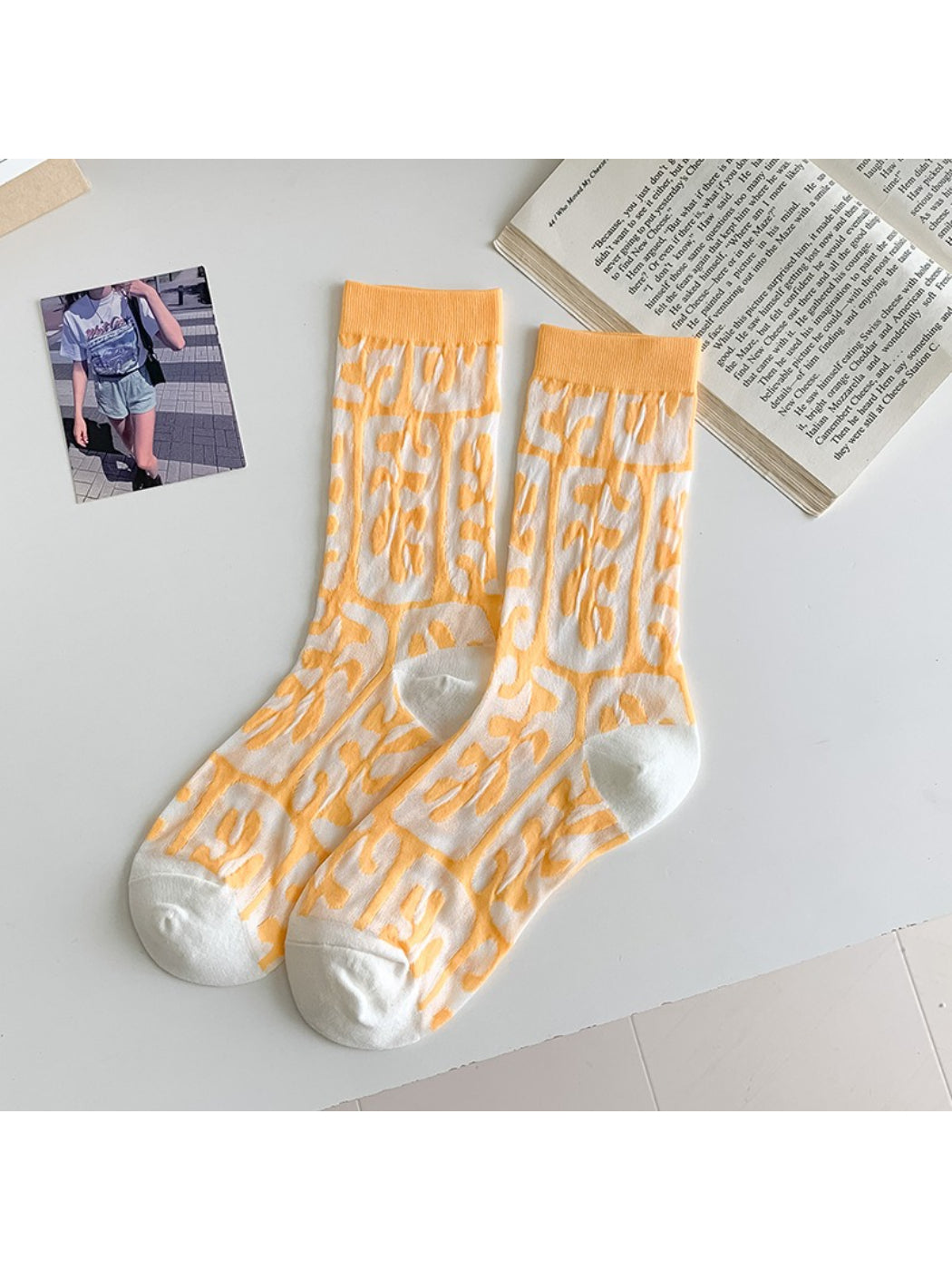 Rufia floral mixed crew socks worn by model standing on grass with visible colorful flowers