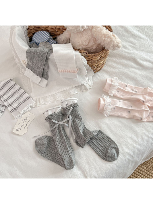Close-up of lace cuff detail on Rufia Romantic Lace Crew Socks in pink