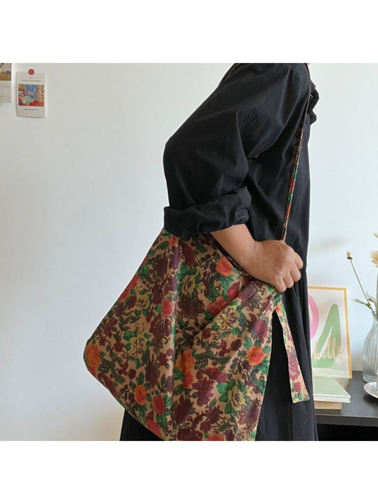 Side view of Cosbai Painterly Rose Slouch Tote showing slouchy shape and rose pattern