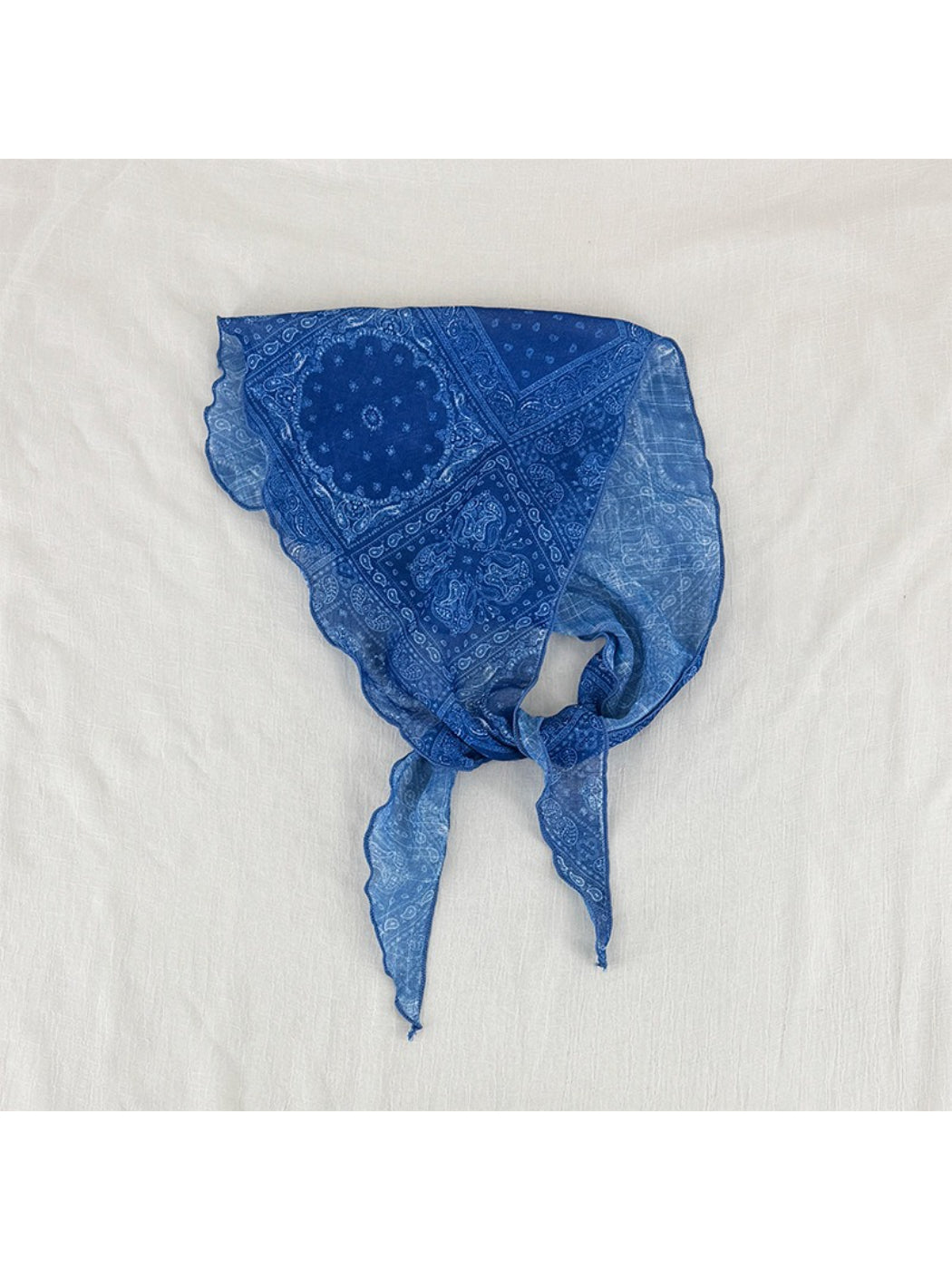 Soft paisley triangle head scarf folded with visible intricate design