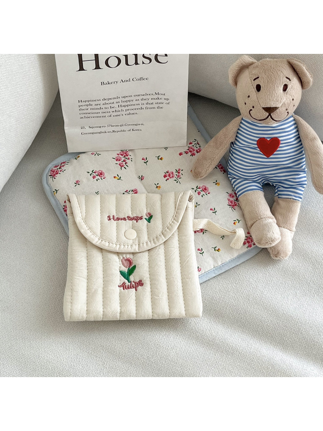 Cosbai cute animal stitch button pouch placed on a wooden surface