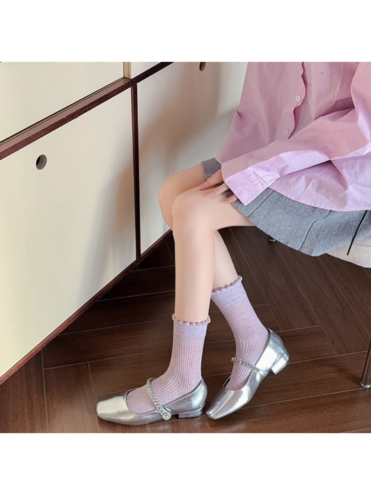 Pair of Rufia rib crew socks laid flat highlighting speckled knit detail