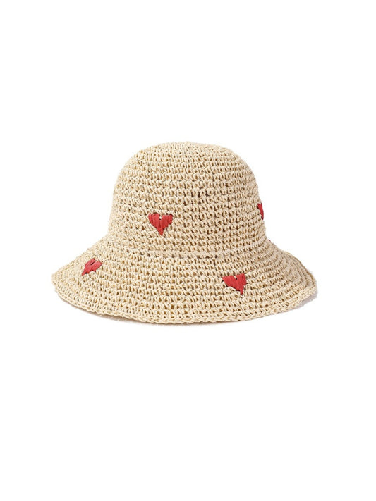 Side view of the straw bucket hat showing woven texture and heart detail
