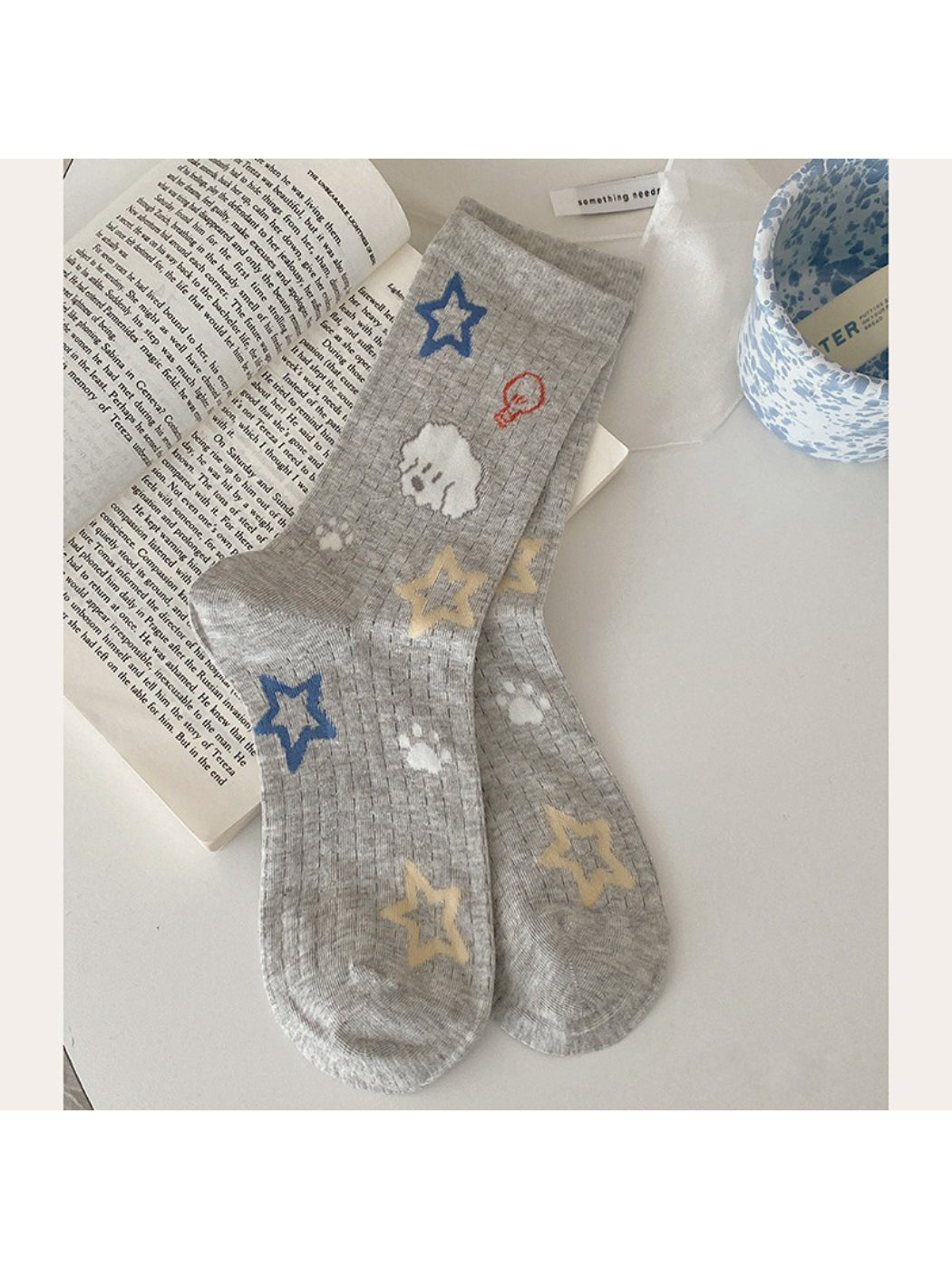 Rufia Playful Star Puppy crew socks paired with casual shoes on wooden floor