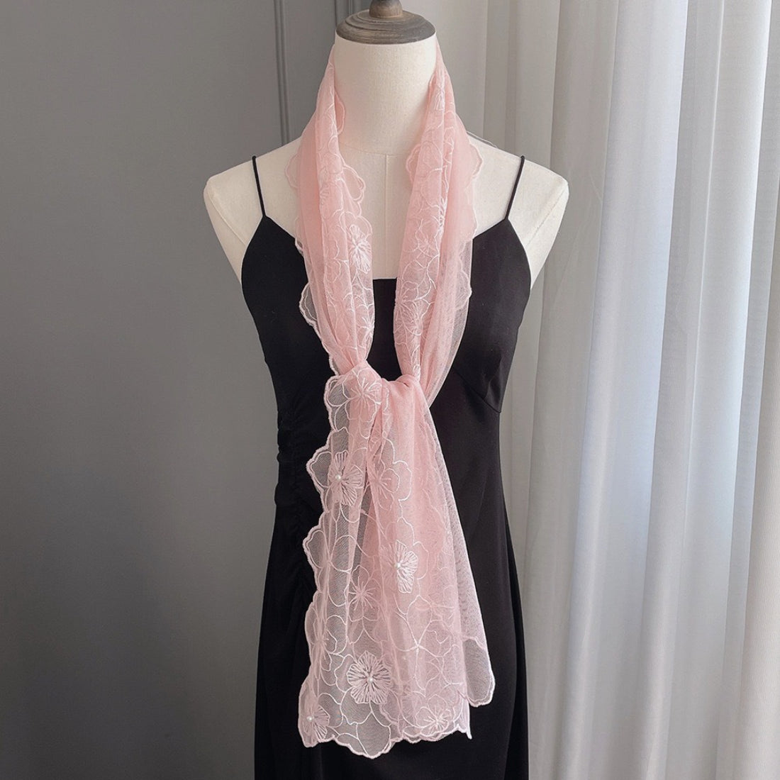 Scarvii floral lace pearl trim scarf displayed on a wooden surface