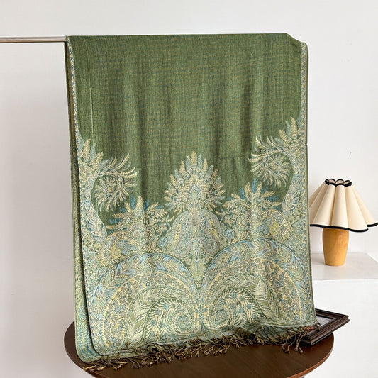 Close-up of intricate paisley pattern on scarf with tassels