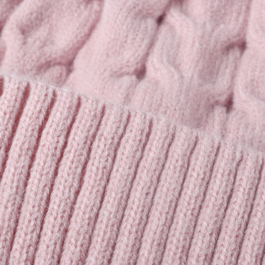 Pink plush lined cable knit pom beanie detail