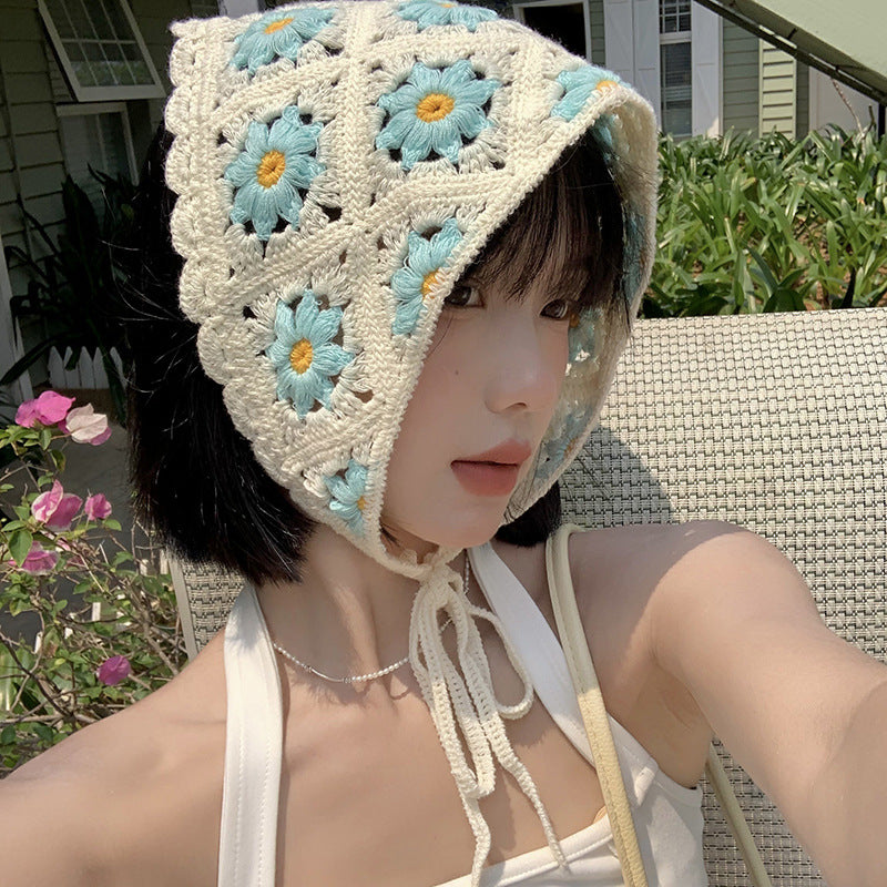 Scarvii crochet daisy smile hairband worn on a model's head