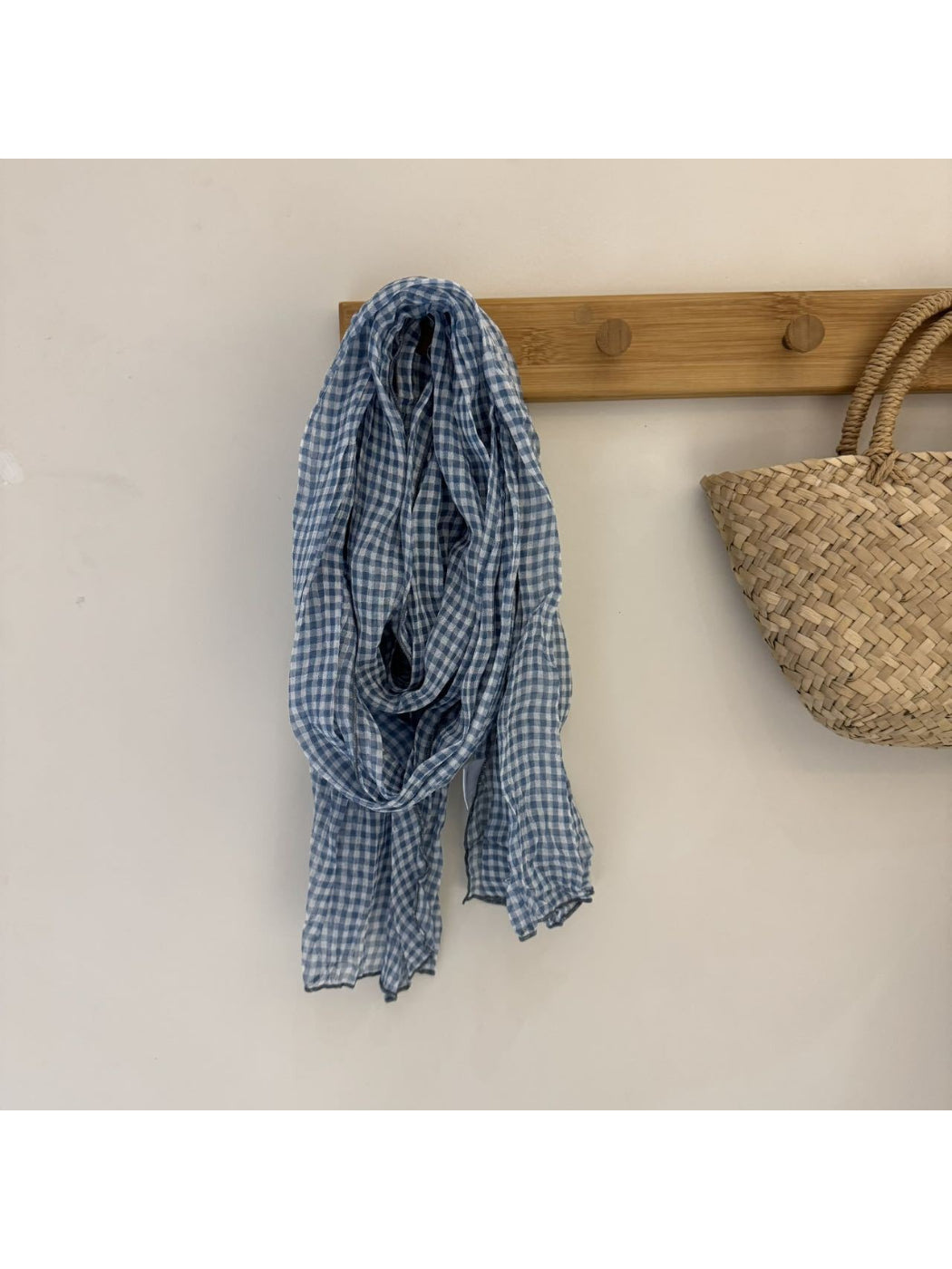 Black and white gingham scarf styled with winter coat outdoors