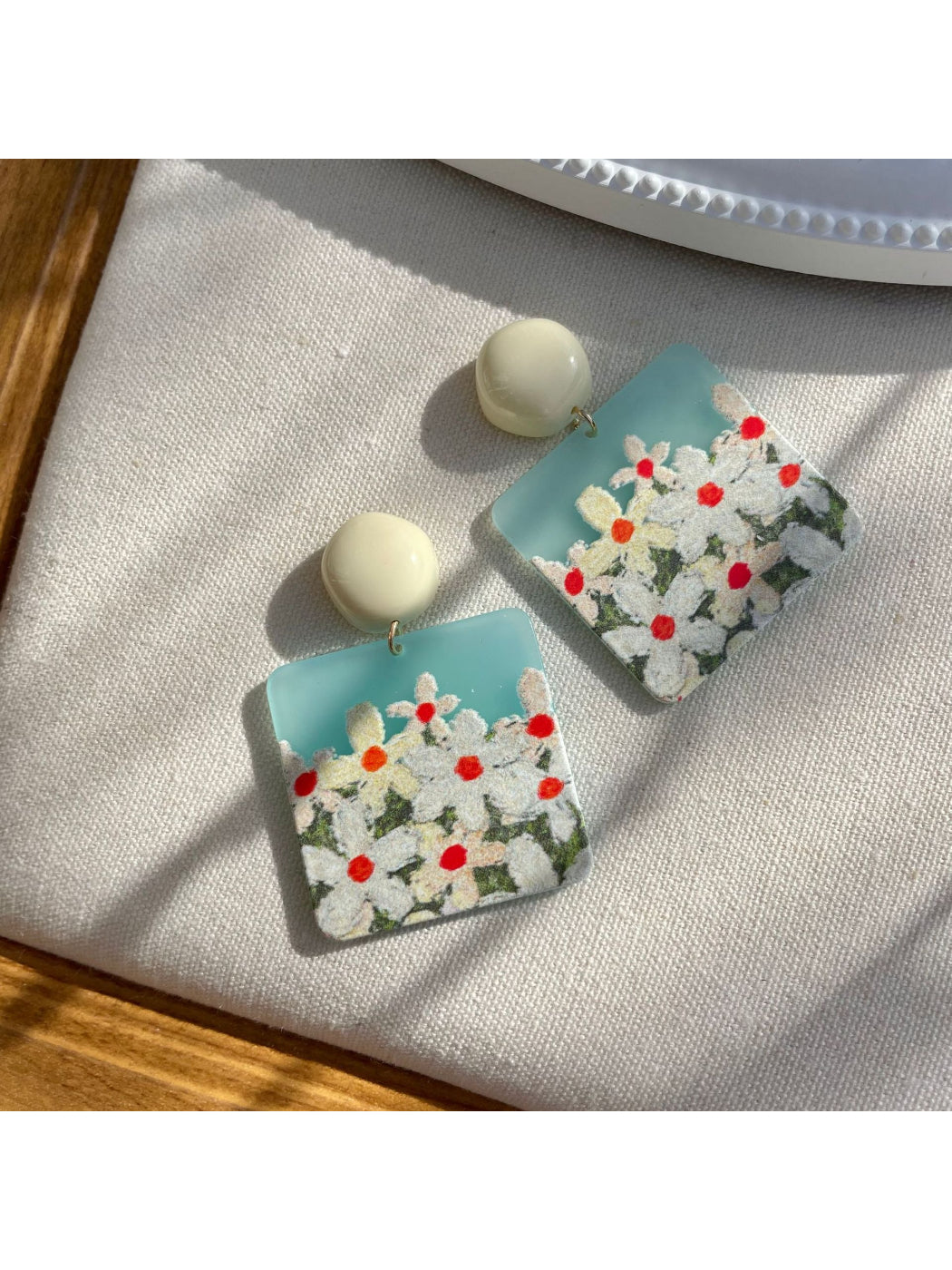 Earwish Daisy Field earrings in a jewelry box with soft fabric lining