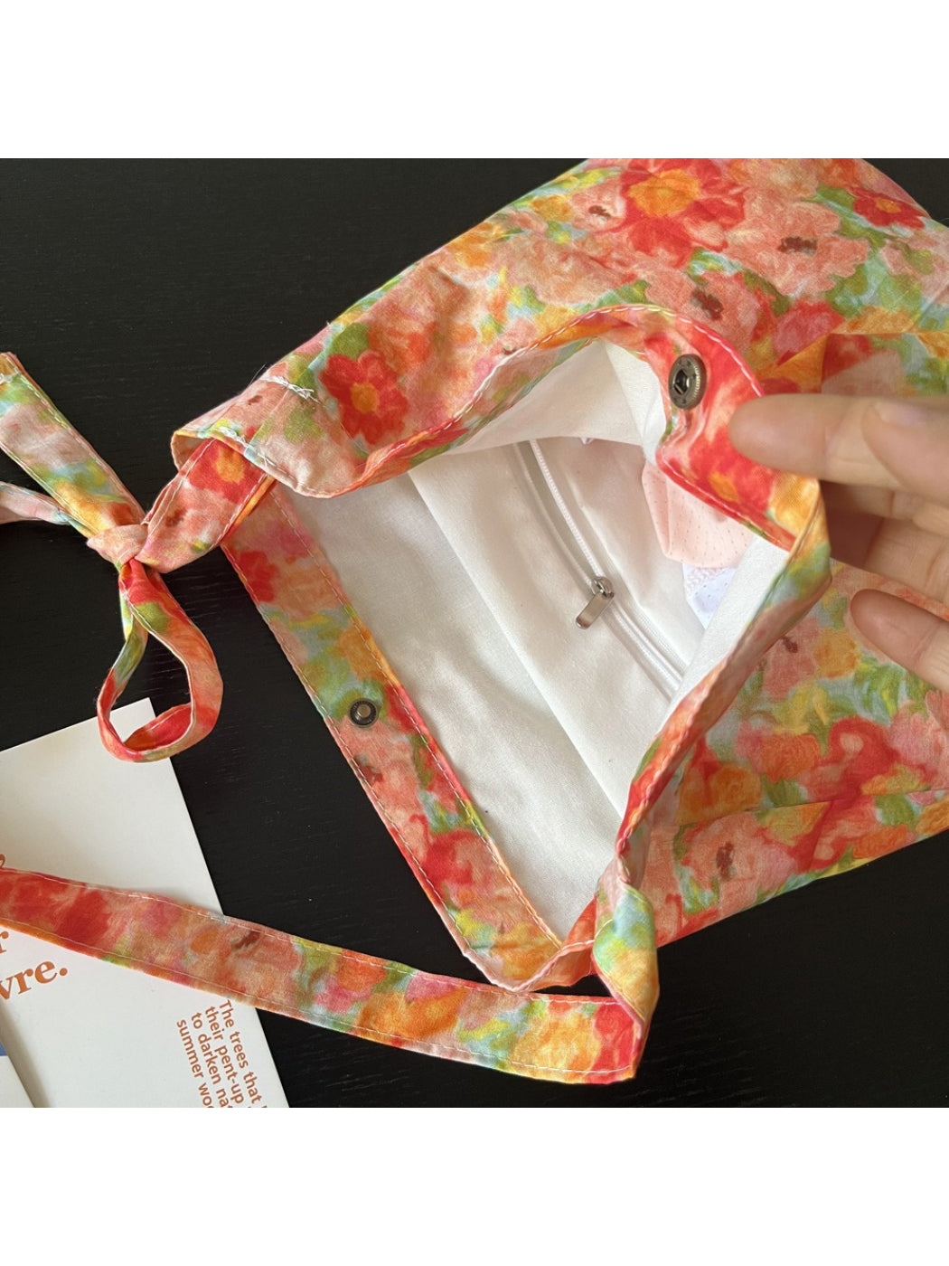 Cosbai Painterly Bloom shoulder bag with dog charm hanging, showing hardware details