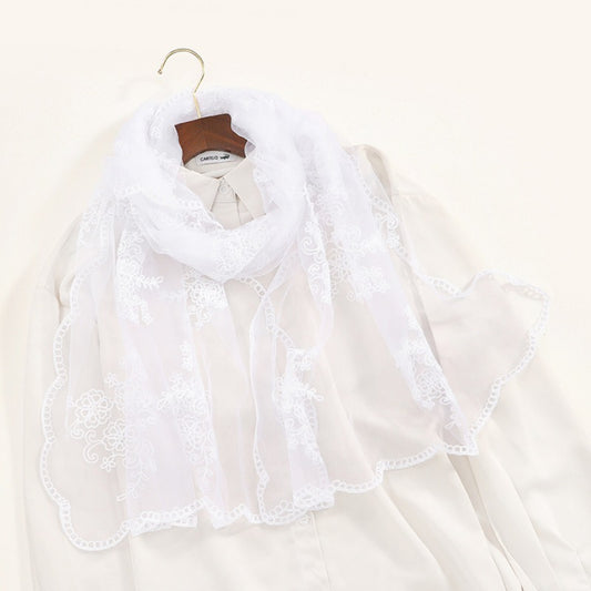 Close-up of delicate baroque embroidery on sheer Scarvii scarf fabric