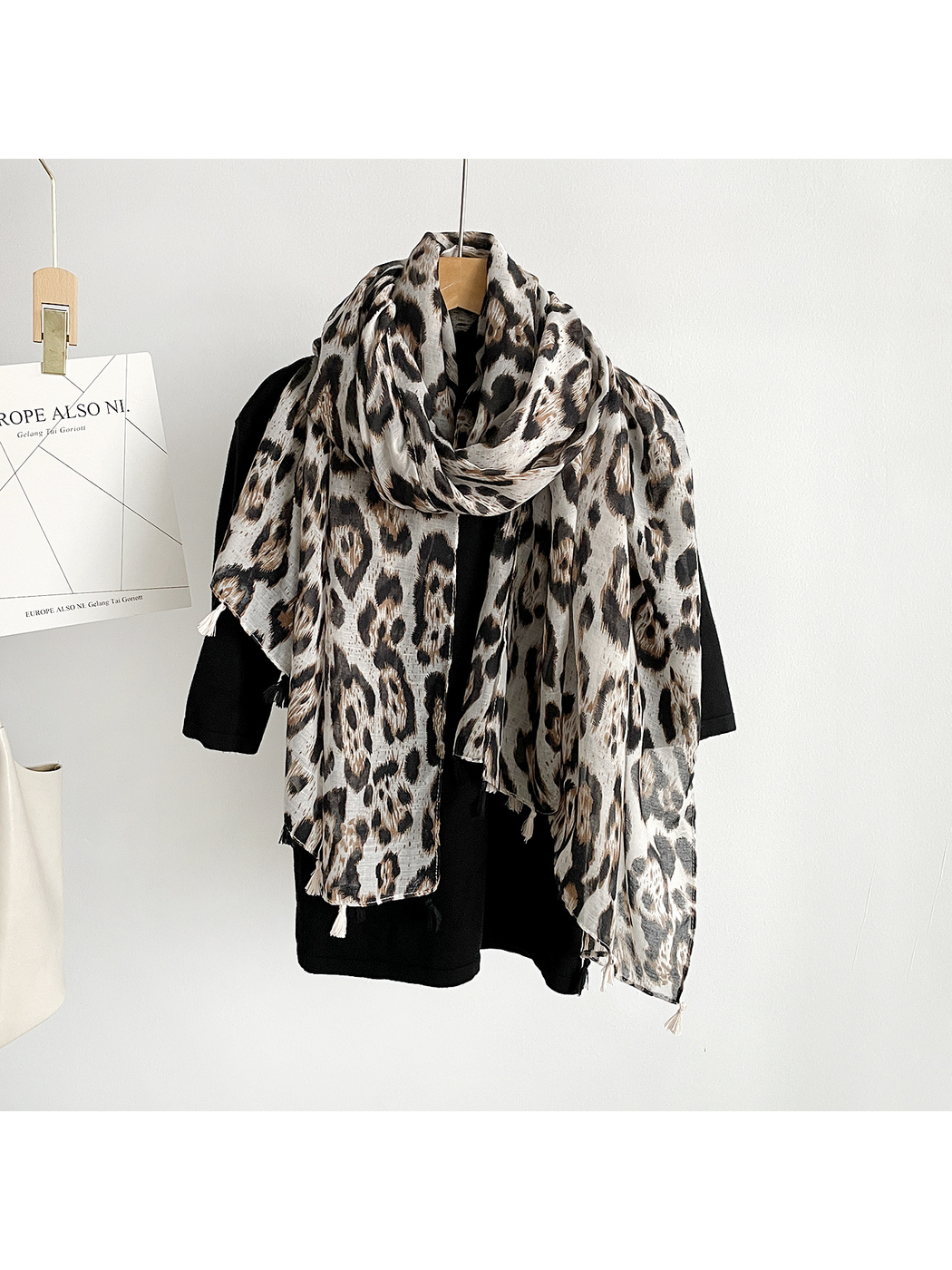 Multicolor leopard-print scarf looped around a black top with both ends hanging down