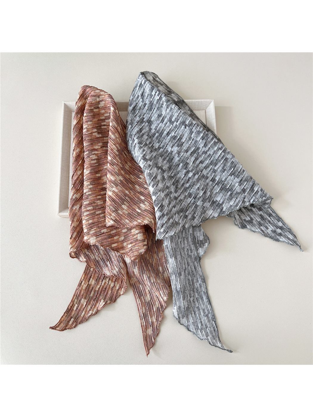 Brown and Gray striped triangle scarves layered with broad panels and loose pointed ends