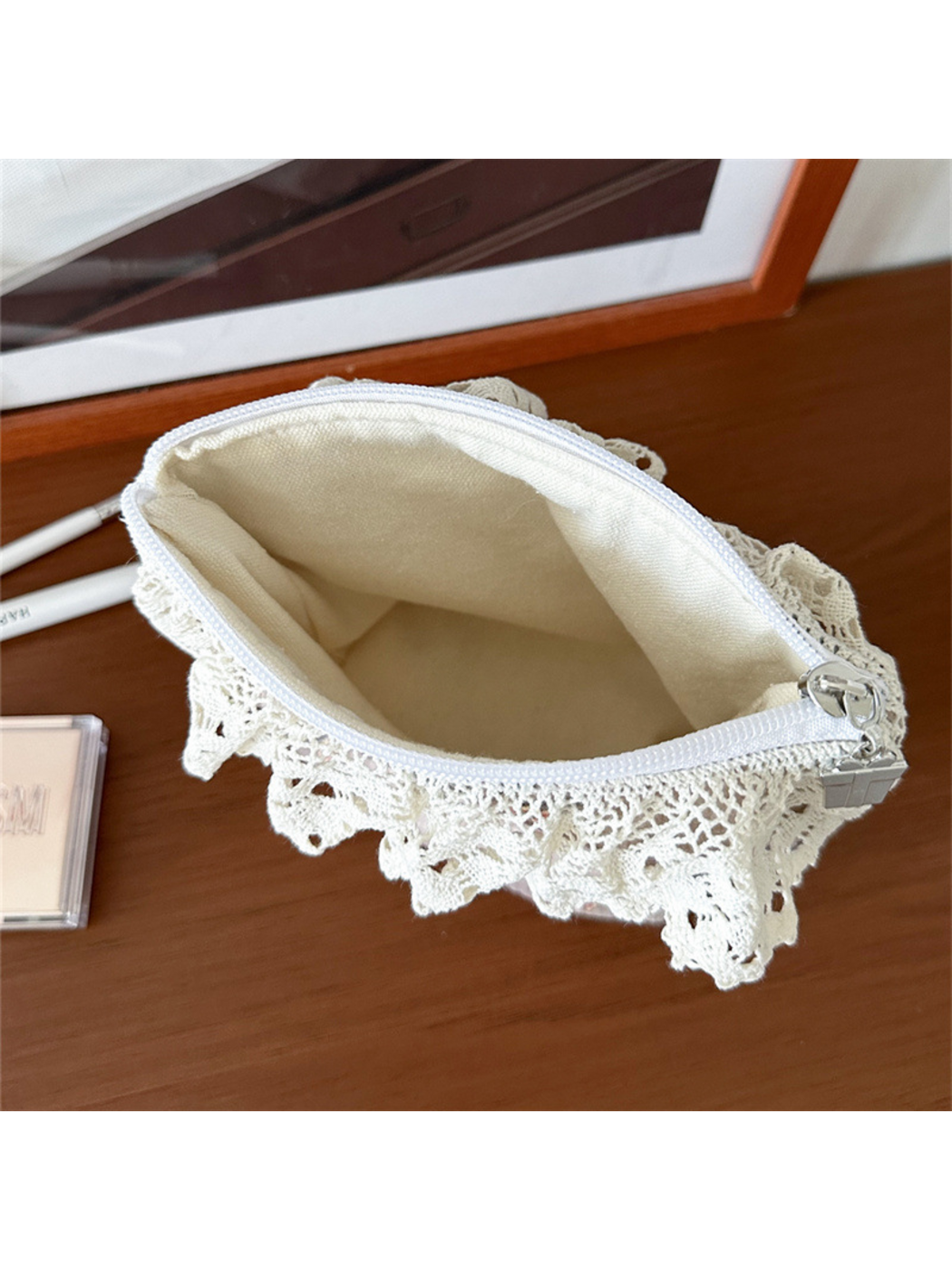 Open pouch viewed from above with scalloped lace around the opening