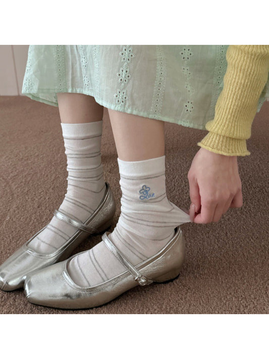 Pair of Rufia pastel stripe knit socks laid flat on white background