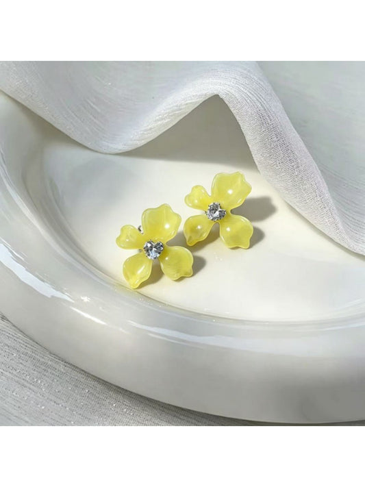 Close-up of Earwish floral stud earrings showing delicate pastel pink flower design