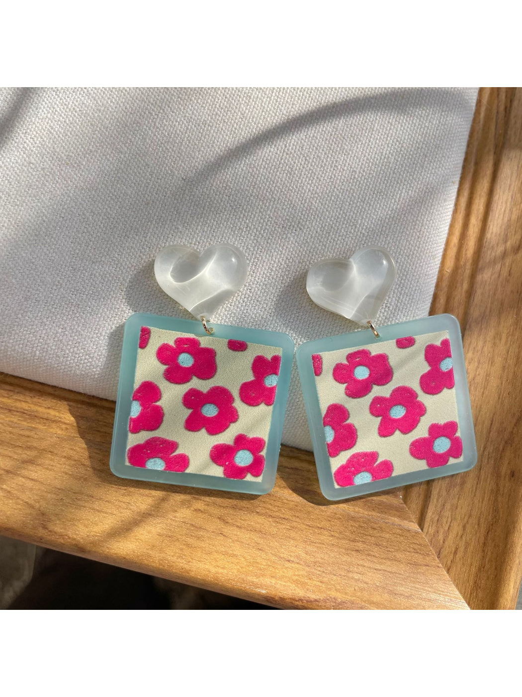 Pair of Earwish Heart Top Floral Drop Earrings displayed on white background showing full design
