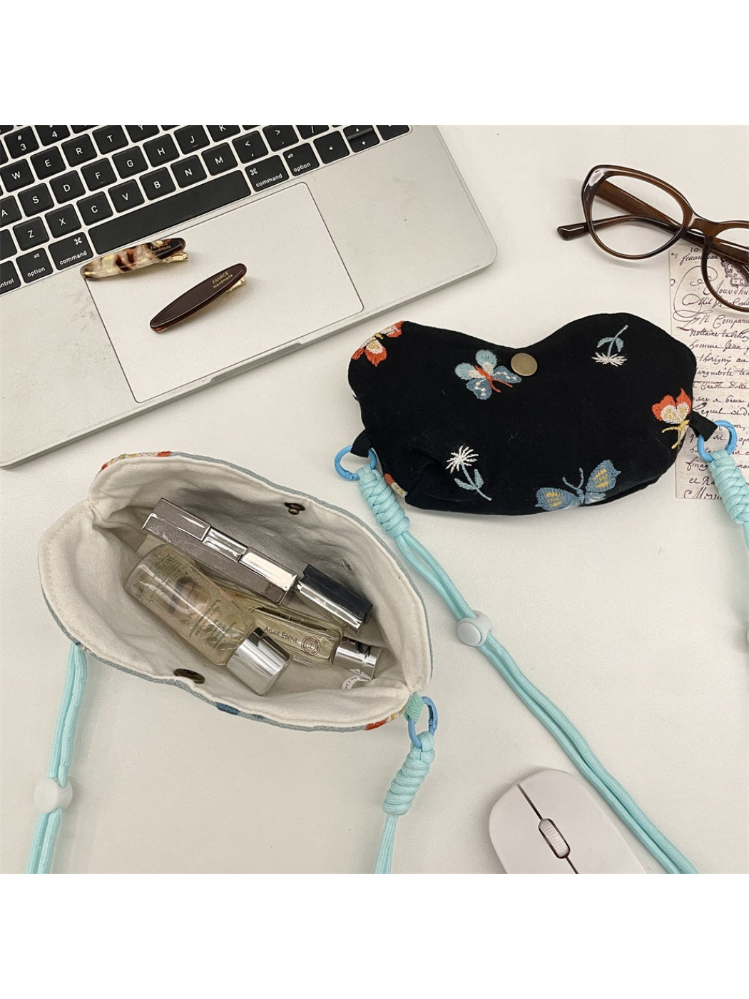 Cosbai mini crossbody pouch bag worn over shoulder with floral embroidery visible