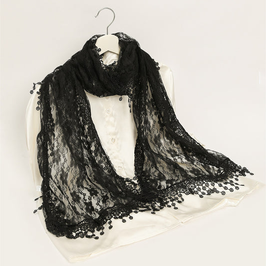 Close-up of delicate floral lace pattern on sheer wrap scarf