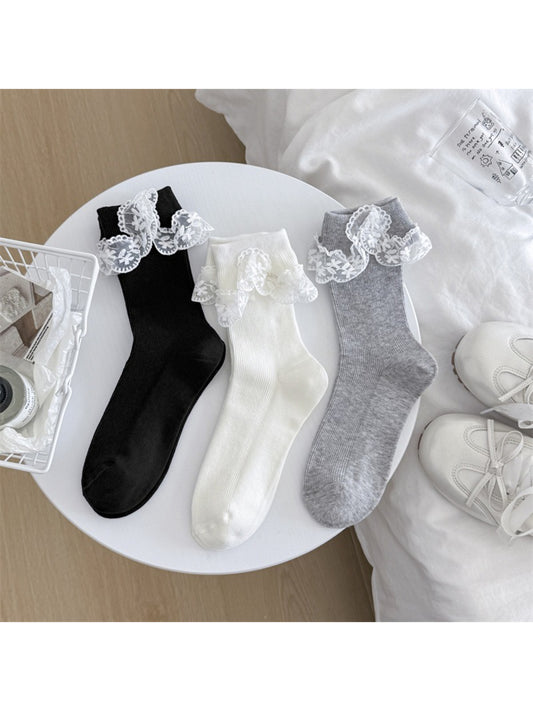 Close-up of Rufia socks showing delicate bow and lace trim detail