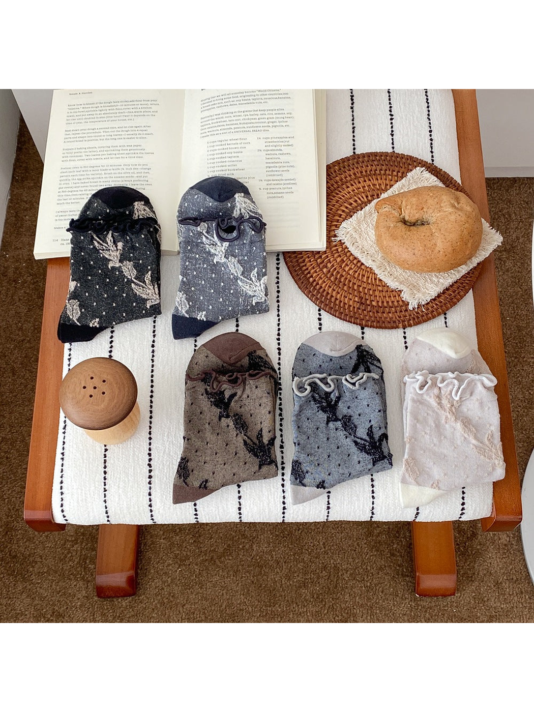 Five sock colors displayed together with floral vine patterns, small dots, and ruffled cuffs.