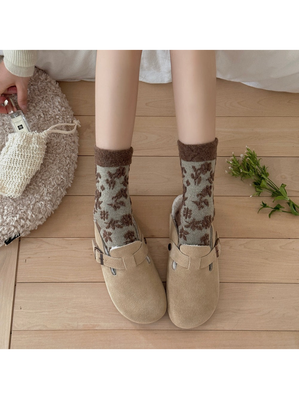 Green floral socks with brown cuffs worn with beige buckle shoes.