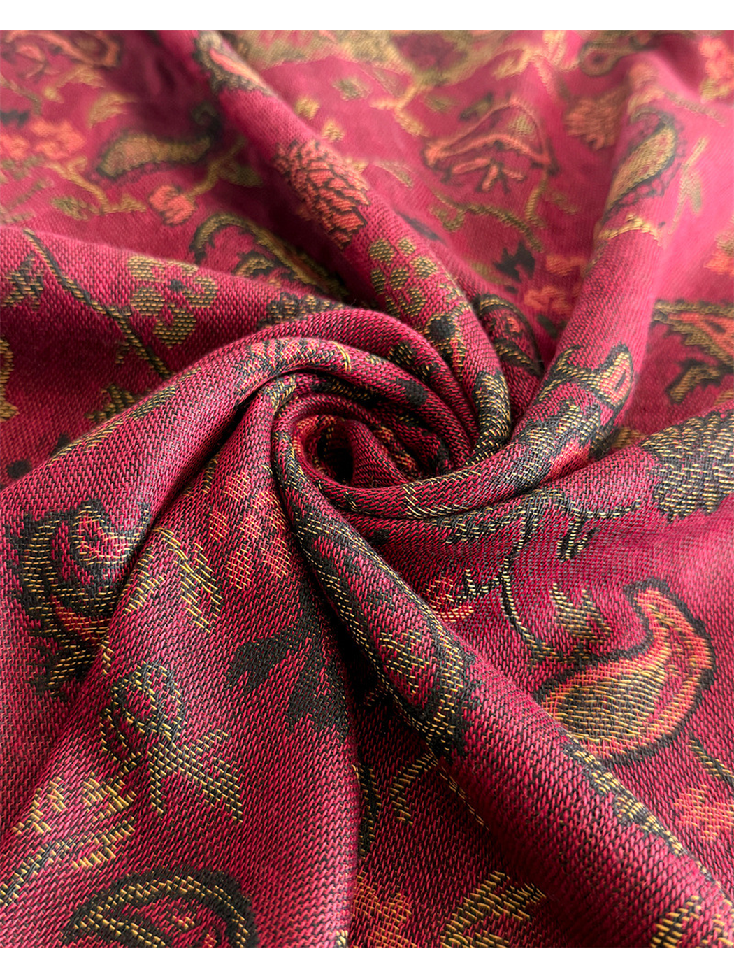Macro view of burgundy paisley fabric gathered into soft folds