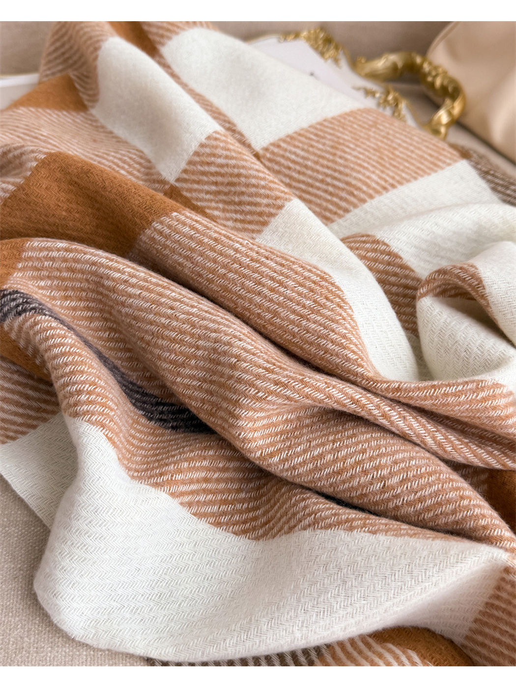 Close-up of the scarf's draped plaid blocks and fine diagonal weave