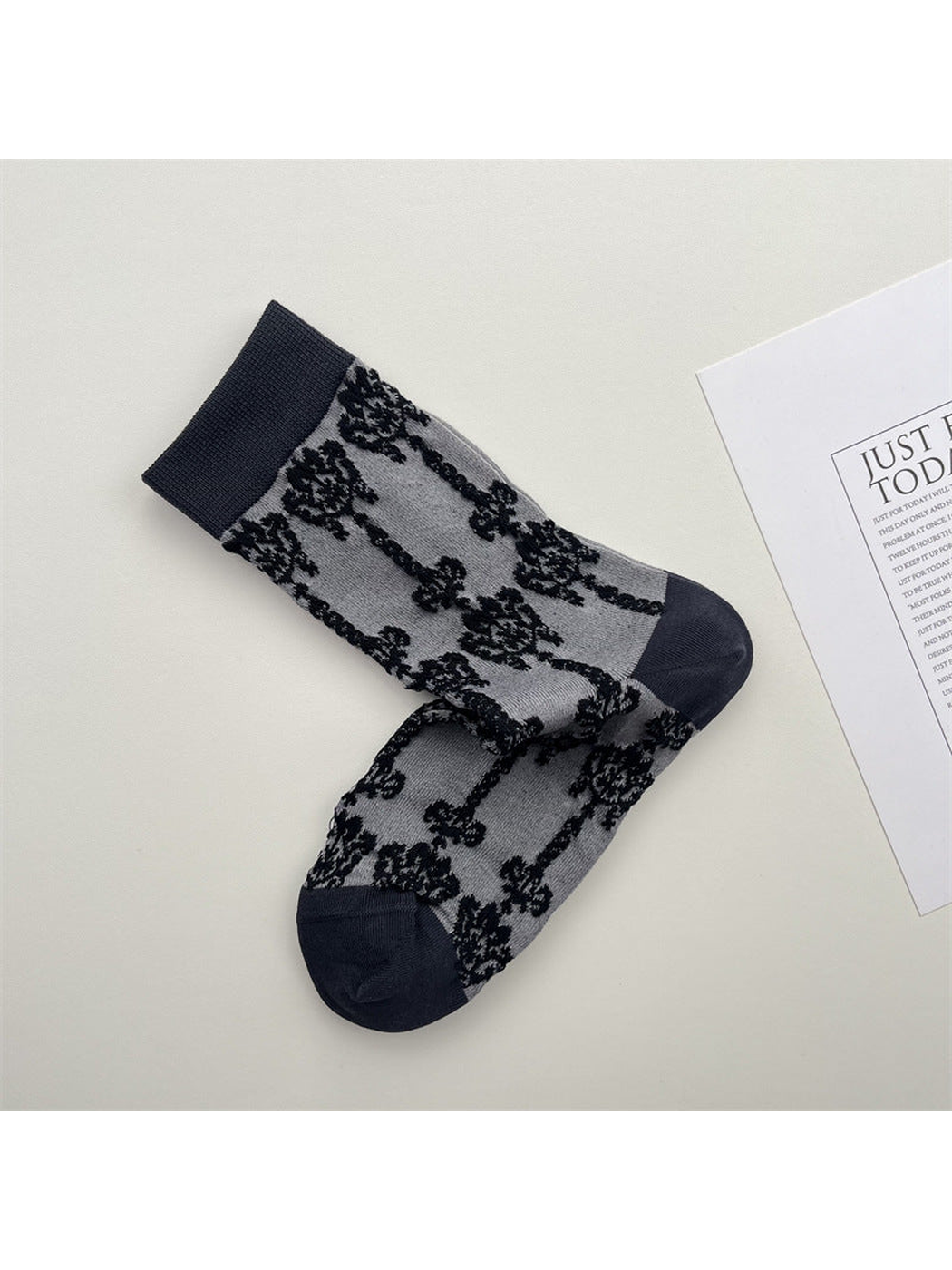 Gray crew socks with black damask pattern and dark trim