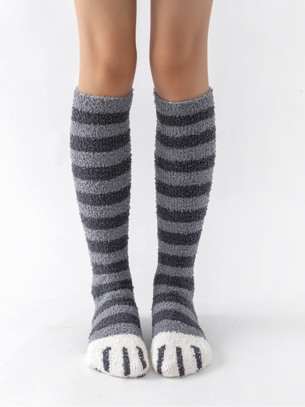 Light gray and dark gray striped fuzzy knee-high socks with white cat-paw toes, front view